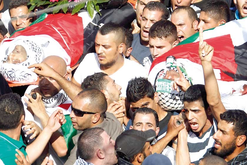 VIOLENCIA. Palestinos portan los cuerpos de Muhammed Shamasne y Omar Al Faqih durante su entierro en Qatna, Palestina.