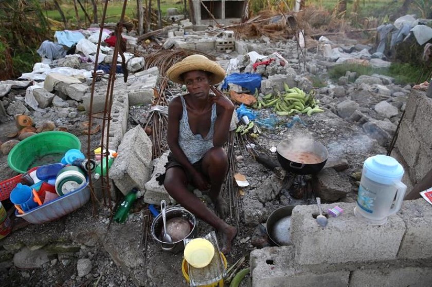 Marie Sanon, cocina en los restos de su casa totalmente destruida tras el paso del huracán Matthew en Haití. Foto: EFE