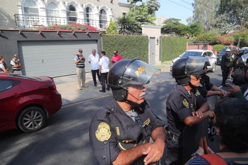 Policías esperan fuera de la casa del ex presidente de Perú, Pedro Pablo Kuczynski, para su detención. FOTO: EFE