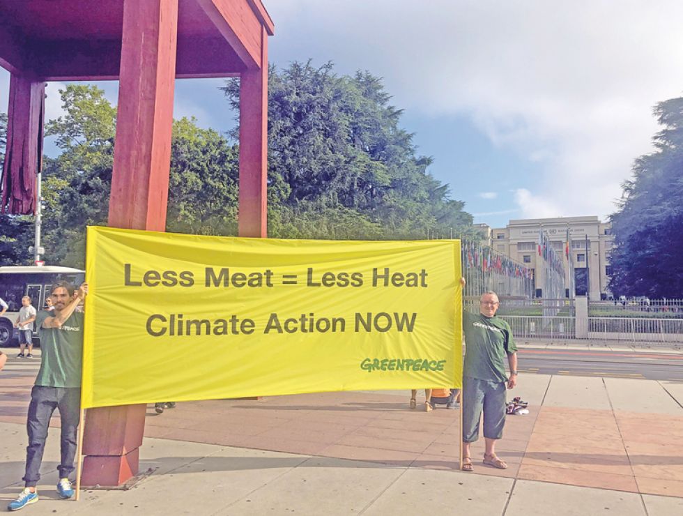 CAMPAÑA. Activistas de la organización ecologista Greenpeace muestran una pancarta con el mensaje 'Menos carne es igual a menos calor".