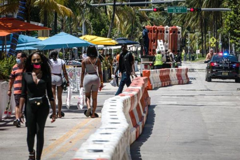 Unas personas pasean antes del toque de queda el 3 de julio en el paseo turístico de Ocean Drive en Miami Beach, Florida.