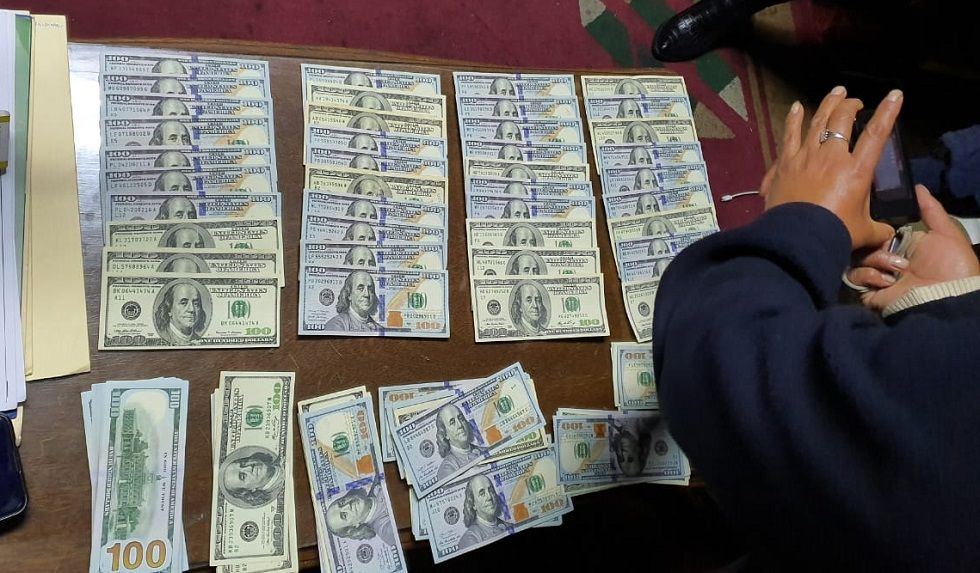 El dinero encontrado en la mochila de una de las autoridades aprehendidas.
