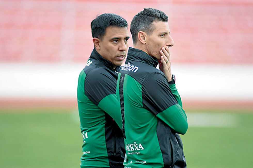 El DT César Farías (i) conversa con su asistente técnico Pablo Escobar en la práctica sostenida ayer.