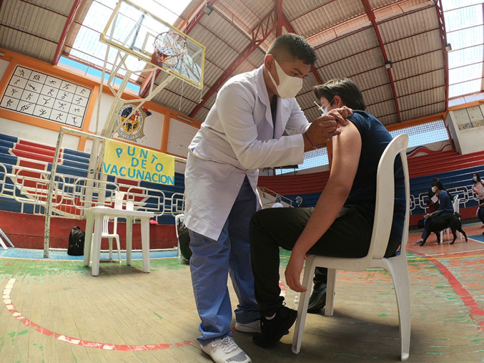 SALUD. Momento en que un joven recibe la vacuna Pfizer en el Coliseo Universitario.