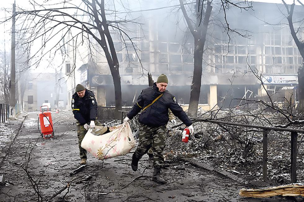 ATAQUES. Policías retiran el cuerpo de una persona fallecida en Kiev durante el bombardeo a una estación de televisión, ayer.