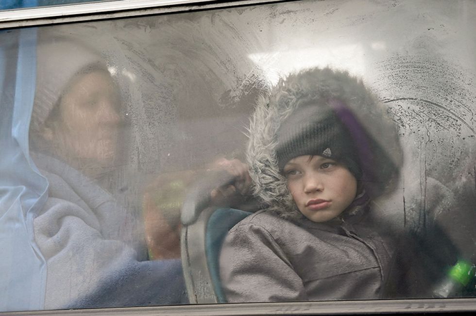 CRISIS. Un niño ucraniano mira a través de la ventana de un autobús que lo conducirá hacia Polonia.